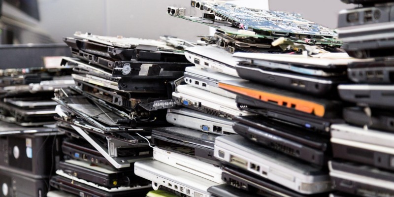 Stacks of laptop ready for secure data destruction.