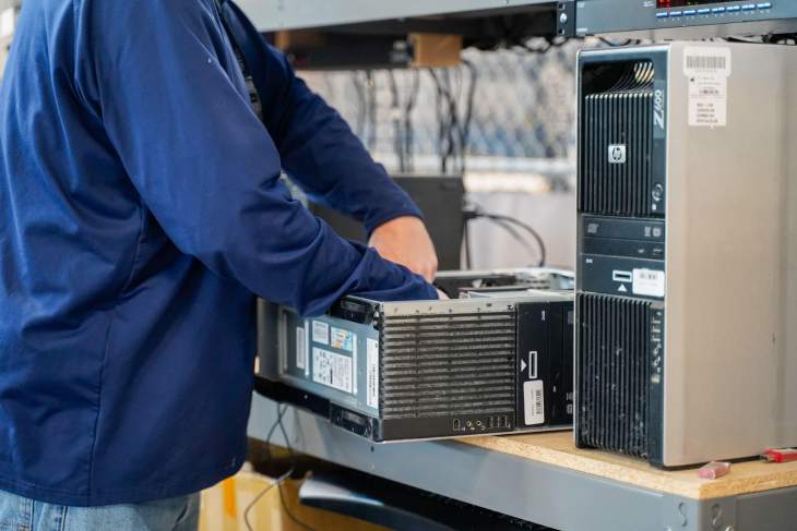 technician disassembling a pc tower