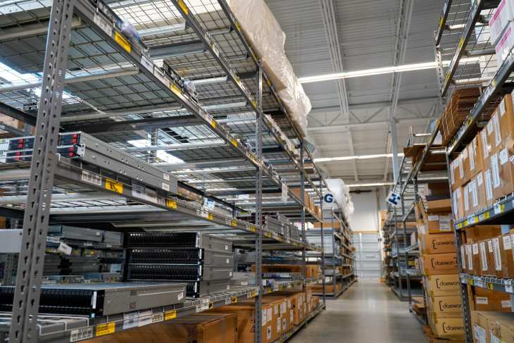 obsolete IT assets and boxes on shelves in a warehouse