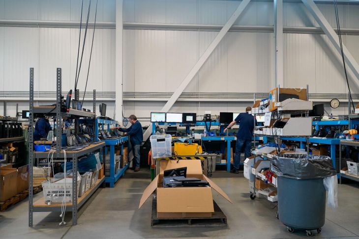 two male technicians working in an ITAD warehouse